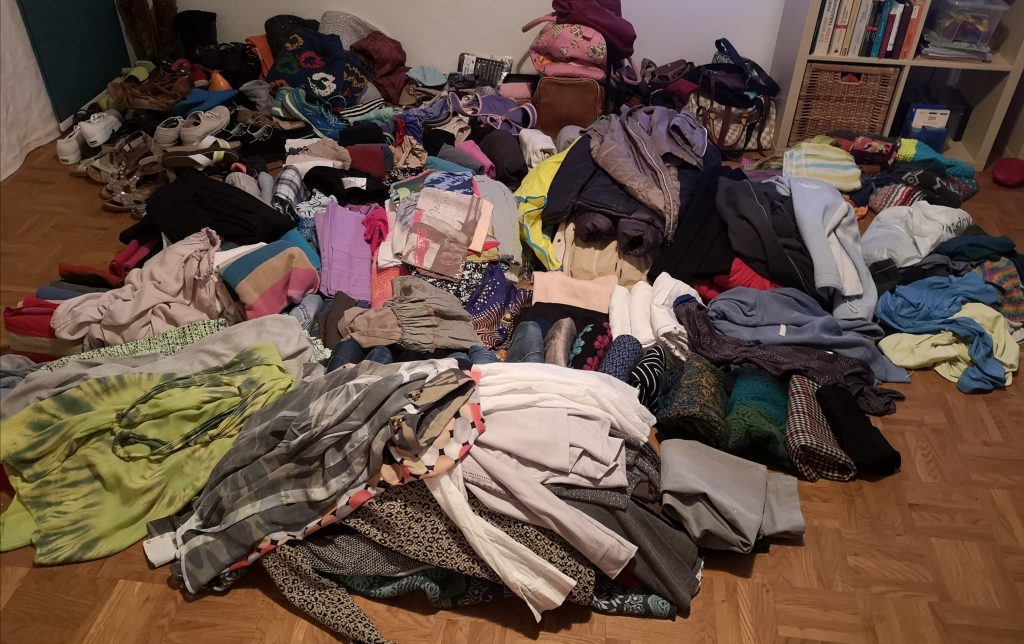 KonMari style of piling up clothes. They will be decluttered during the next step.