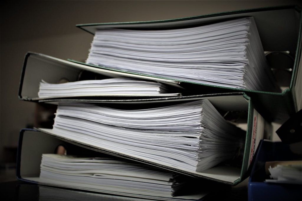 Stapled folders filled with papers categorised according to specific topics