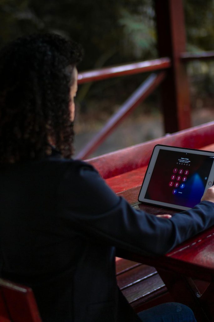 A woman sitting in front of a locked iPad